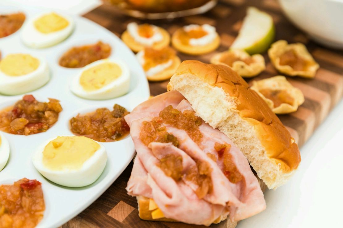 Relish served with deviled eggs and ham sandwiches